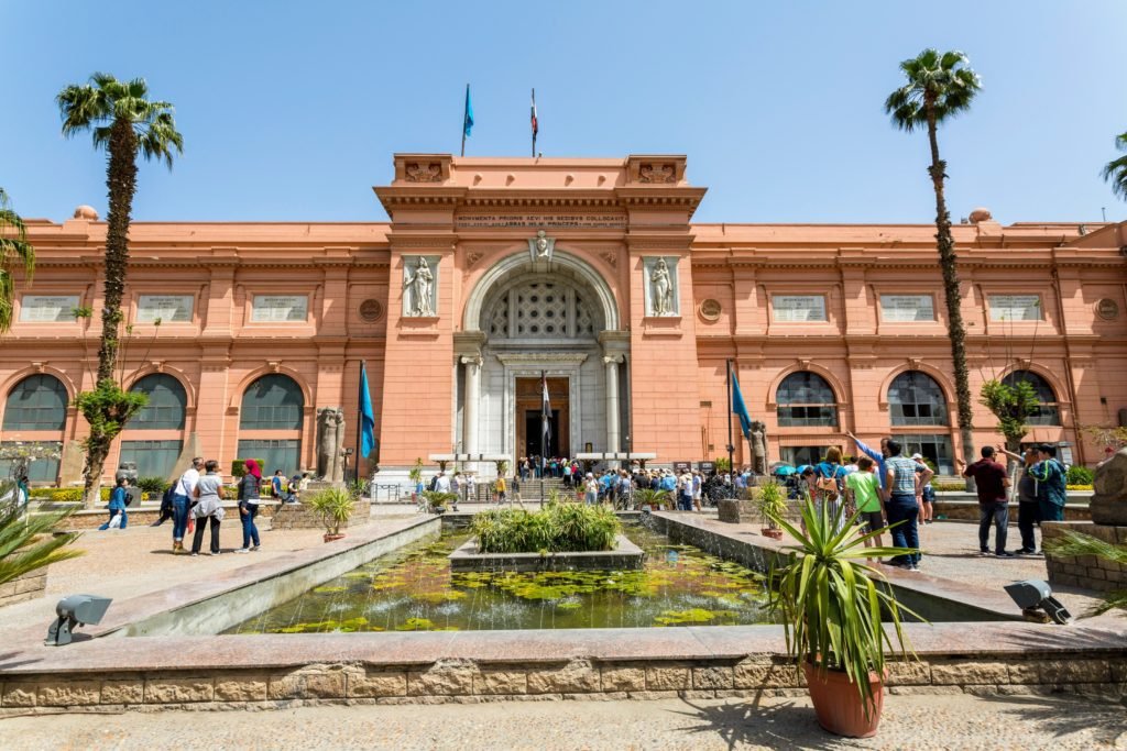 Exterior of the Cairo Museum. Two Palm trees adorn the entrance way.